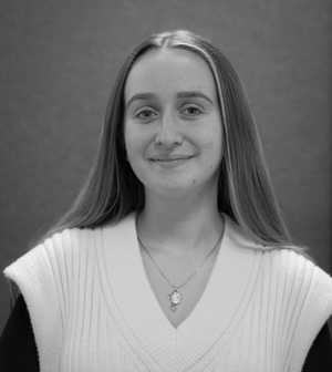 A black & white portrait of Stile team member Anastasia Reid smiling at the camera