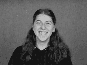 A black & white portrait of Stile team member Sofia Linardou smiling at the camera