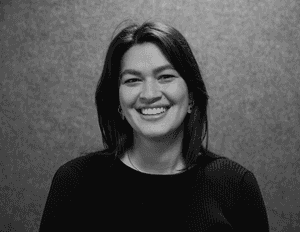 A black & white portrait of Stile team member Penelope Creagh smiling at the camera