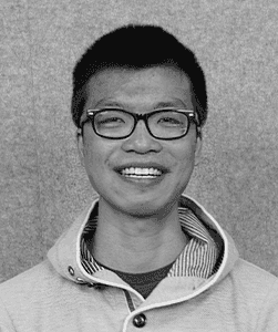 A black & white portrait of Stile team member Honman Yau smiling at the camera
