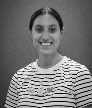 A black & white portrait of Stile team member Gina DiBenedetto smiling at the camera