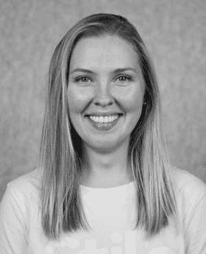 A black & white portrait of Stile team member Charlotte Newall smiling at the camera