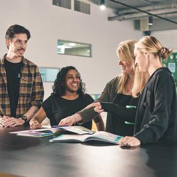 Four people in a classroom