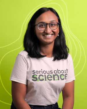 A black & white portrait of Stile team member Pooja Prabhakaran smiling at the camera