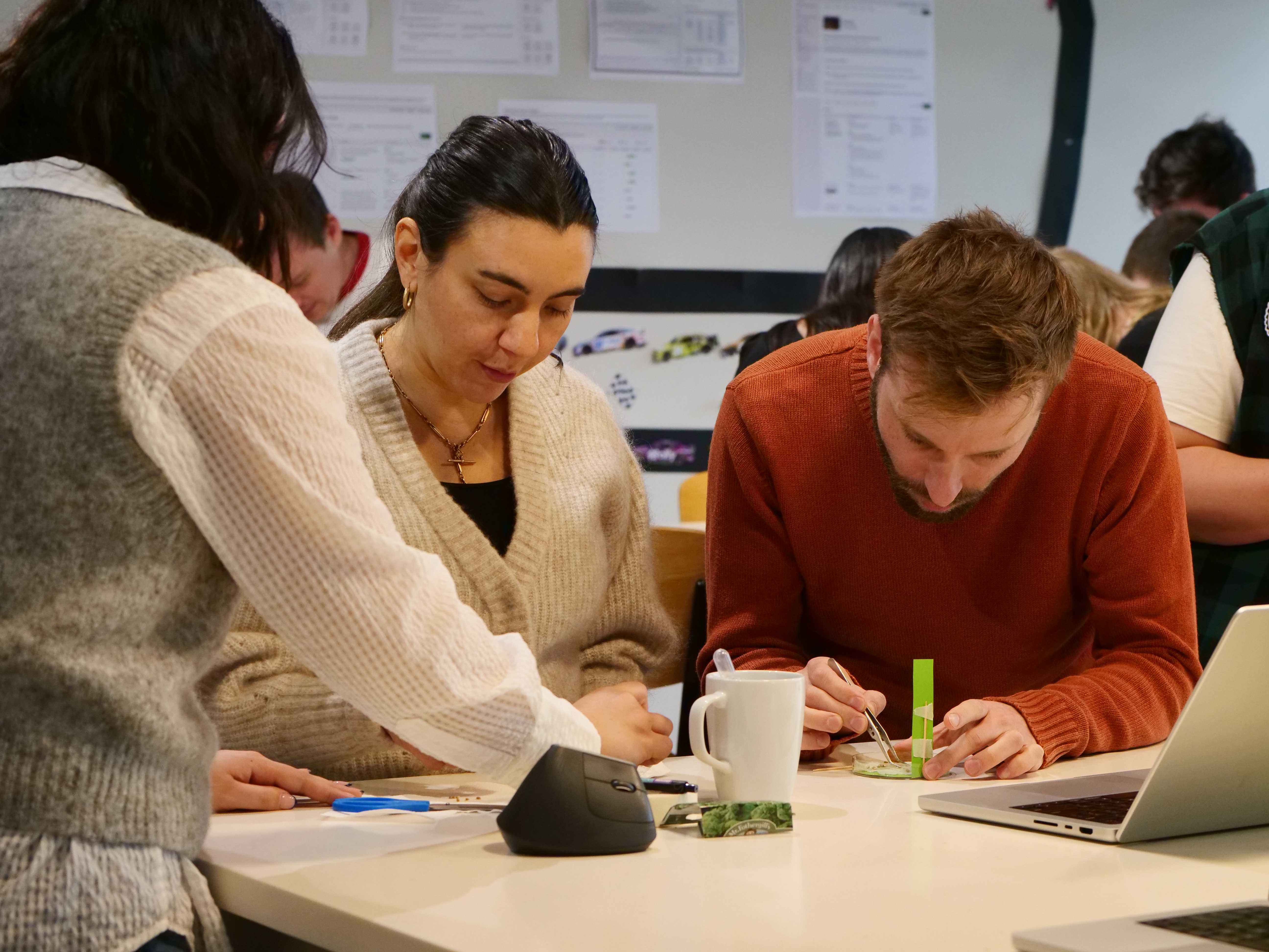 Three people working on a science experiment together.