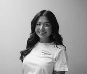 A black & white portrait of Stile team member Vanessa Santiago smiling at the camera