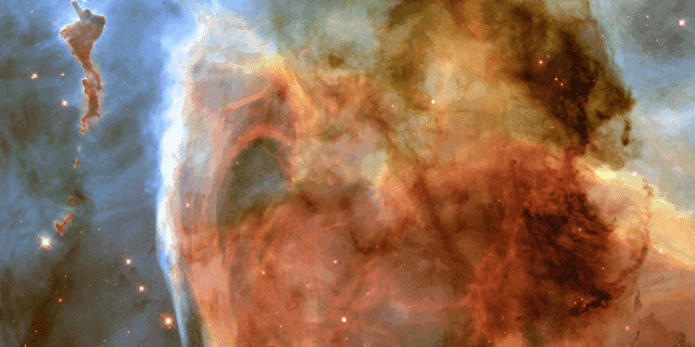 A nebula that is mostly orange, with some bluish grey in the background