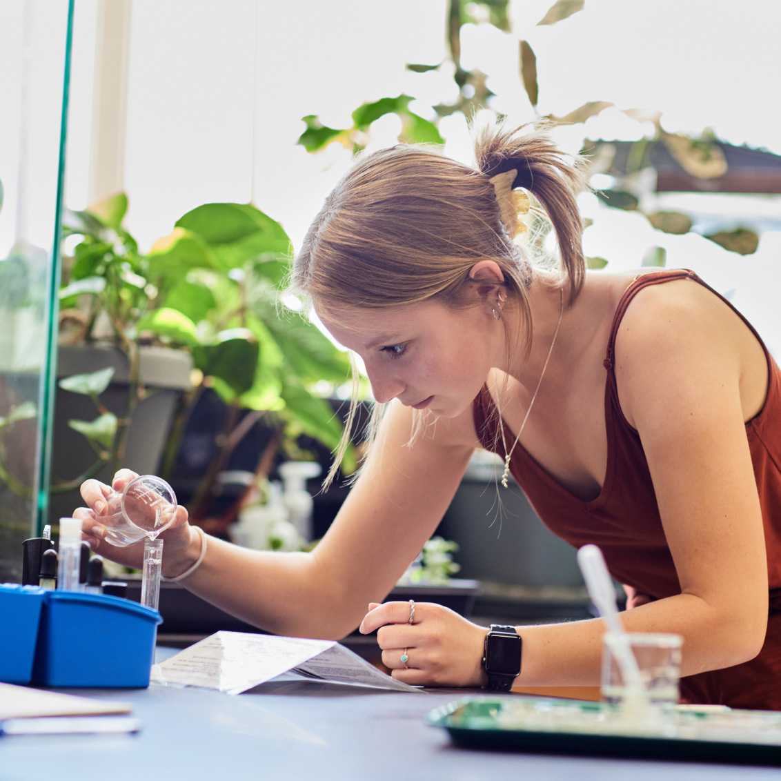 A person in a classroom, performing experiments