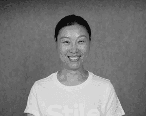 A black & white portrait of Stile team member Nicole Li smiling at the camera