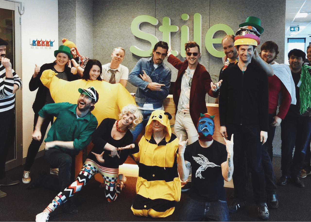 A group shot of some of the Stile team. They are dressed up in silly outfits, or are in a goofy pose