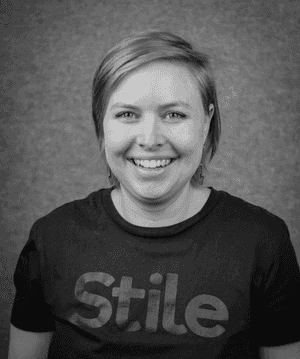 A black & white portrait of Stile team member Katrina Don Paul smiling at the camera